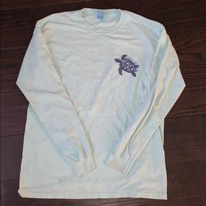 Woman’s long sleeve shirt, light teal, has stains